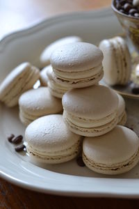 Macaroons in plate on table