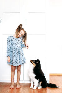 Full length of woman with cat on floor