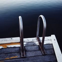 High angle view of railing on pier at lake