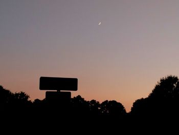 Silhouette basketball hoop against sky during sunset