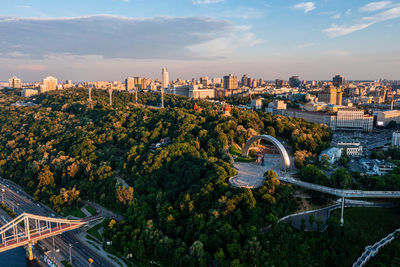 Sunset over summer kiev with arch of friendship of peoples.