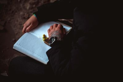 Midsection of woman reading book