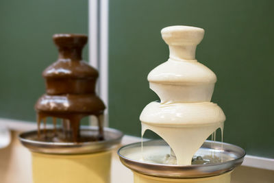 Chocolate fountains against wall