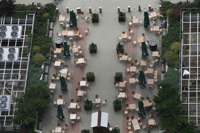 High angle view of empty tables and chairs at sidewalk cafe