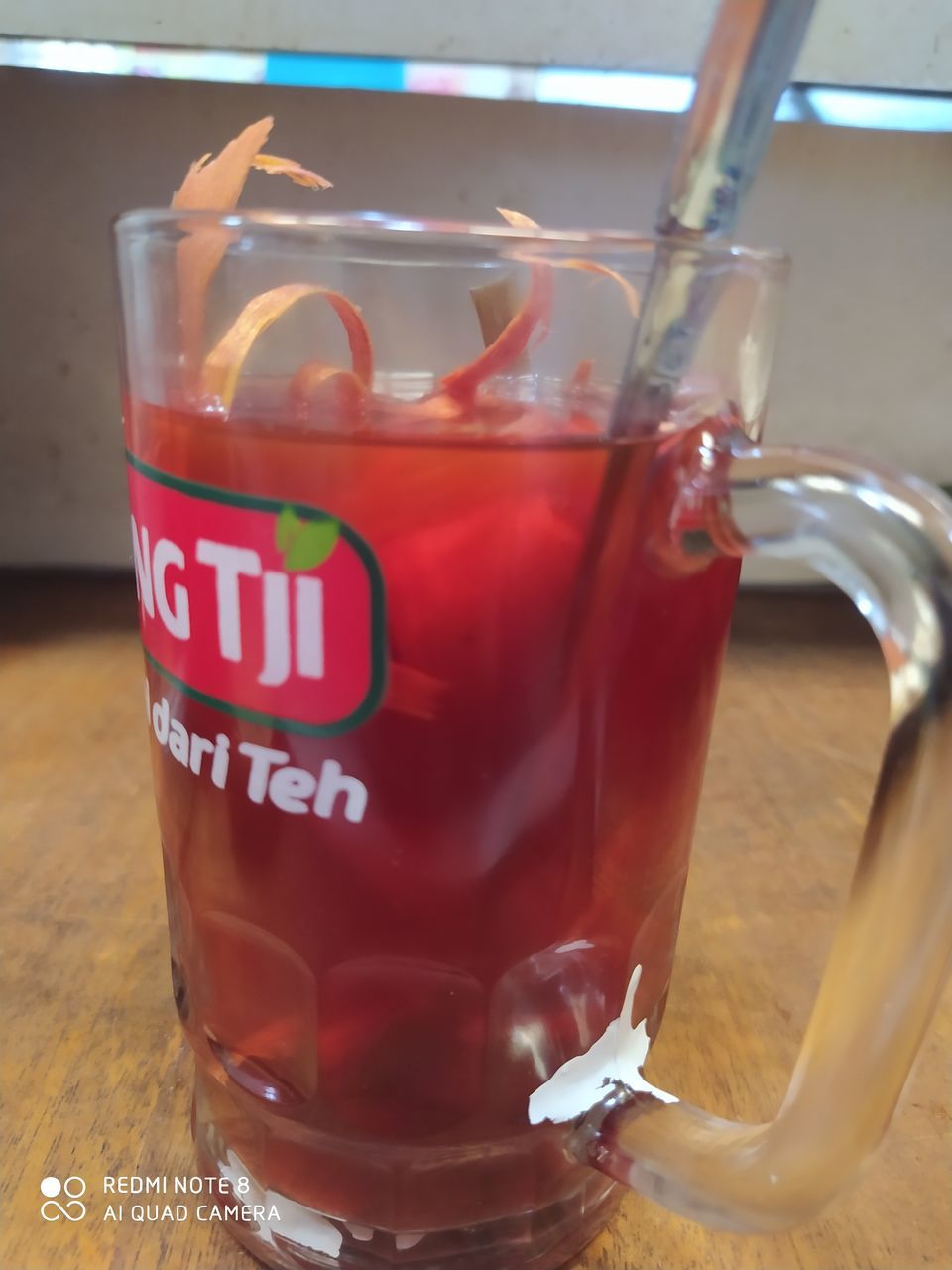 CLOSE-UP OF DRINK ON GLASS TABLE