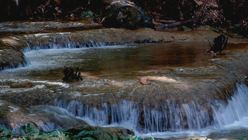 View of waterfall along river