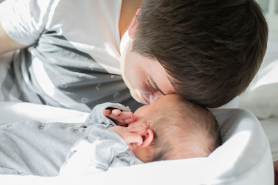 Close-up of baby sleeping on bed