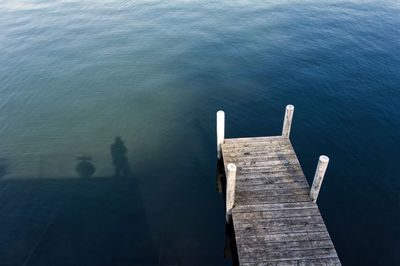 High angle view of people on pier by sea