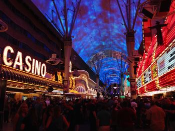 Group of people in illuminated building at night