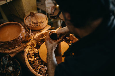 Side view of man preparing food