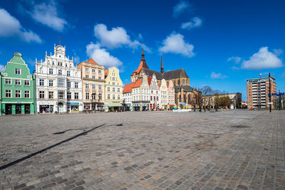 Buildings in town against sky