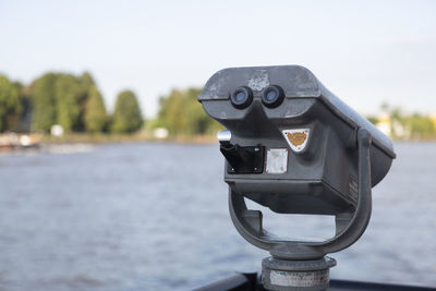 Close-up of camera against sky