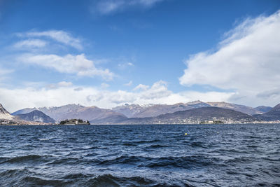 Scenic view of sea and mountains against sky