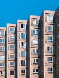 Low angle view of buildings against blue sky