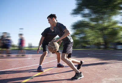 Teenage boys playing baskeball