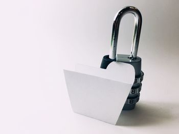 Close-up of padlocks against white background