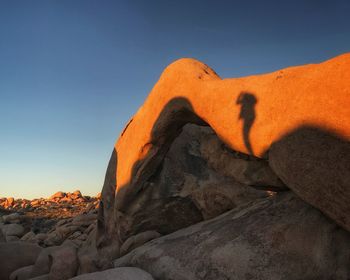 Low angle view of rock against sky during sunset