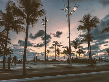 Silhouette palm trees against sky during sunset