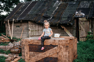 Full length of young man sitting on hay