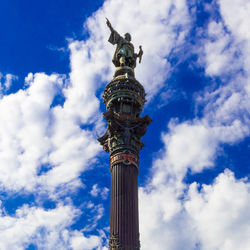 Low angle view of statue against cloudy sky