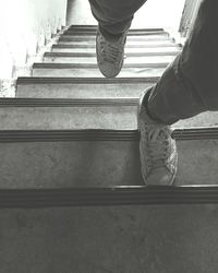 Low section of woman standing on tiled floor