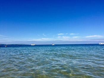 Scenic view of sea against blue sky