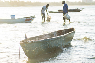 People on boat at sea shore