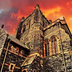 Low angle view of old building against sky during sunset