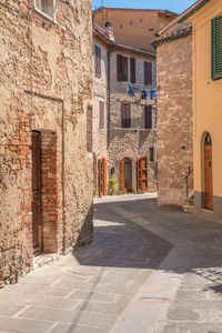 Siena province - view of narrow streets of the town, no people walking around  during midday siesta 