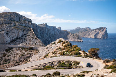 Scenic view of sea and mountains against sky