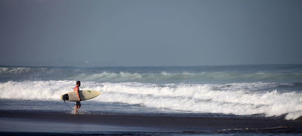 People surfing on beach