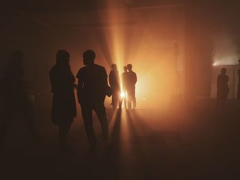 Silhouette men standing in corridor