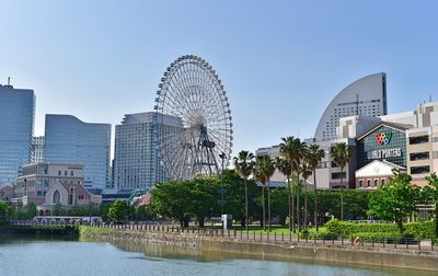 Ferris wheel against buildings in city