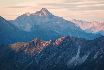 Scenic view of snowcapped mountains against sky during sunset