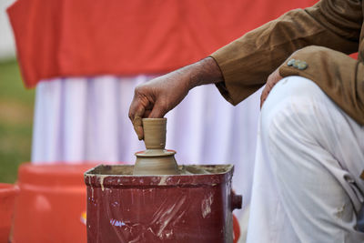 Midsection of man working in factory