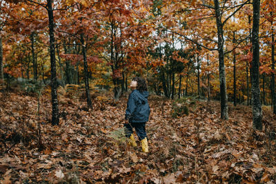 Cute girl hiking on autumn woods