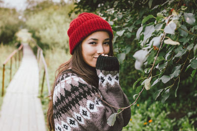 Portrait of smiling young woman in park during winter