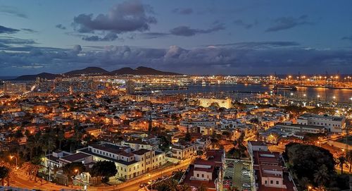 High angle shot of illuminated cityscape against sky at dusk