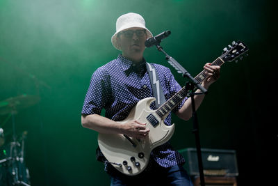 Full length of man playing guitar