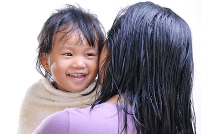 Portrait of happy mother and daughter against clear sky