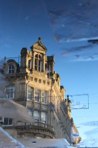 Low angle view of built structure against blue sky