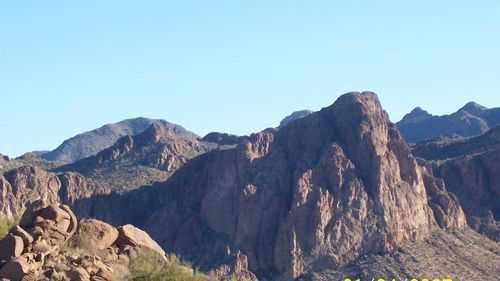 Low angle view of mountains against clear blue sky