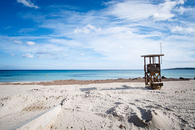 Lifeguard hut on beach against sky