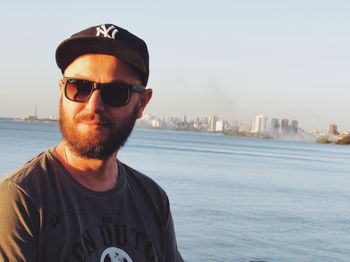 Portrait of man in sunglasses against clear sky