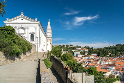 Panoramic view of buildings against blue sky