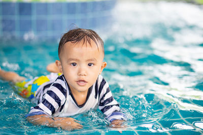 Portrait of boy swimming in pool