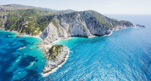 Panoramic shot of rocks on beach against sky