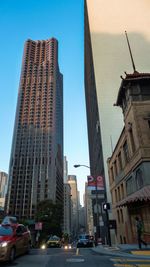 View of city street against blue sky