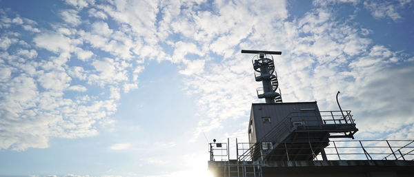 Low angle view of communications tower against sky