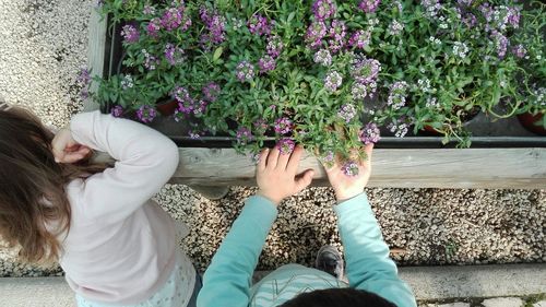 Low section of friends with flowers